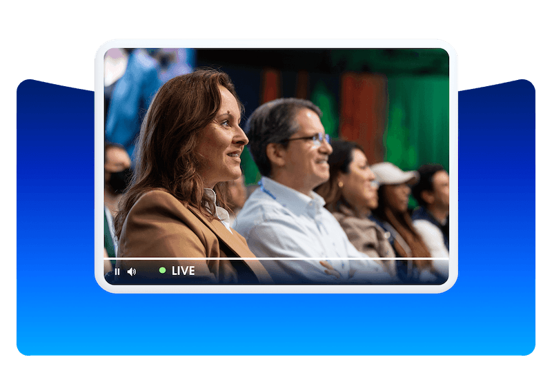 A video UI inside a frame showing audience members watching a live event.